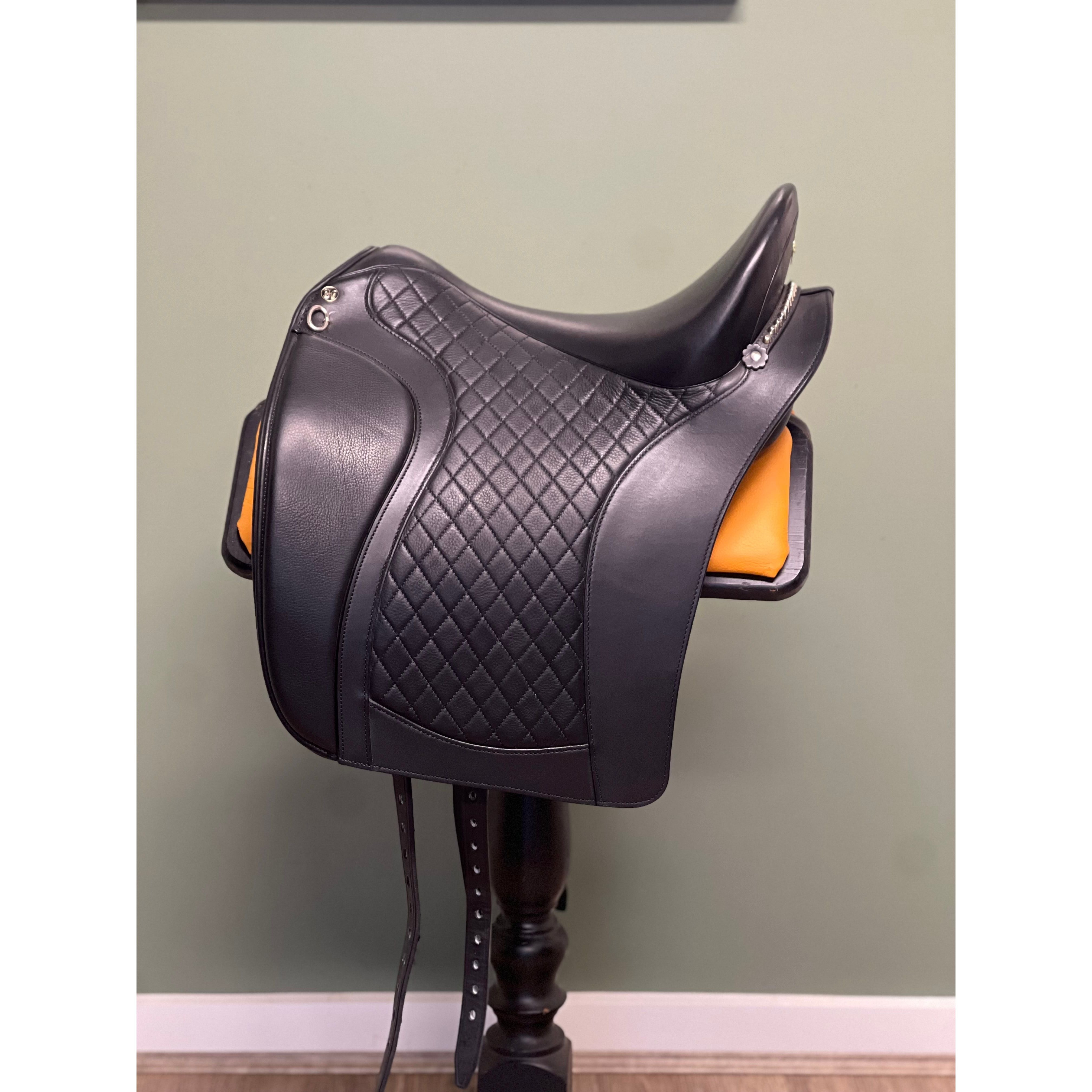 A black StrideFree Baroque saddle featuring a soft padded seat, interchangeable gullet system, and stainless steel safety stirrup bars.